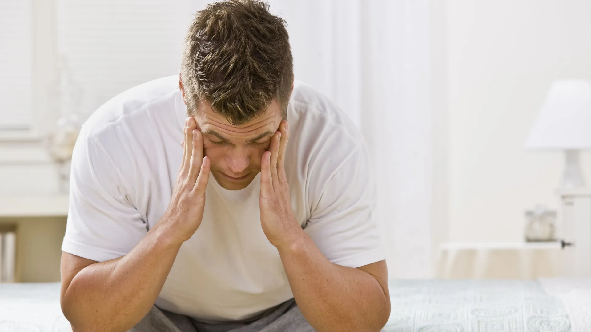 Man with face in palms