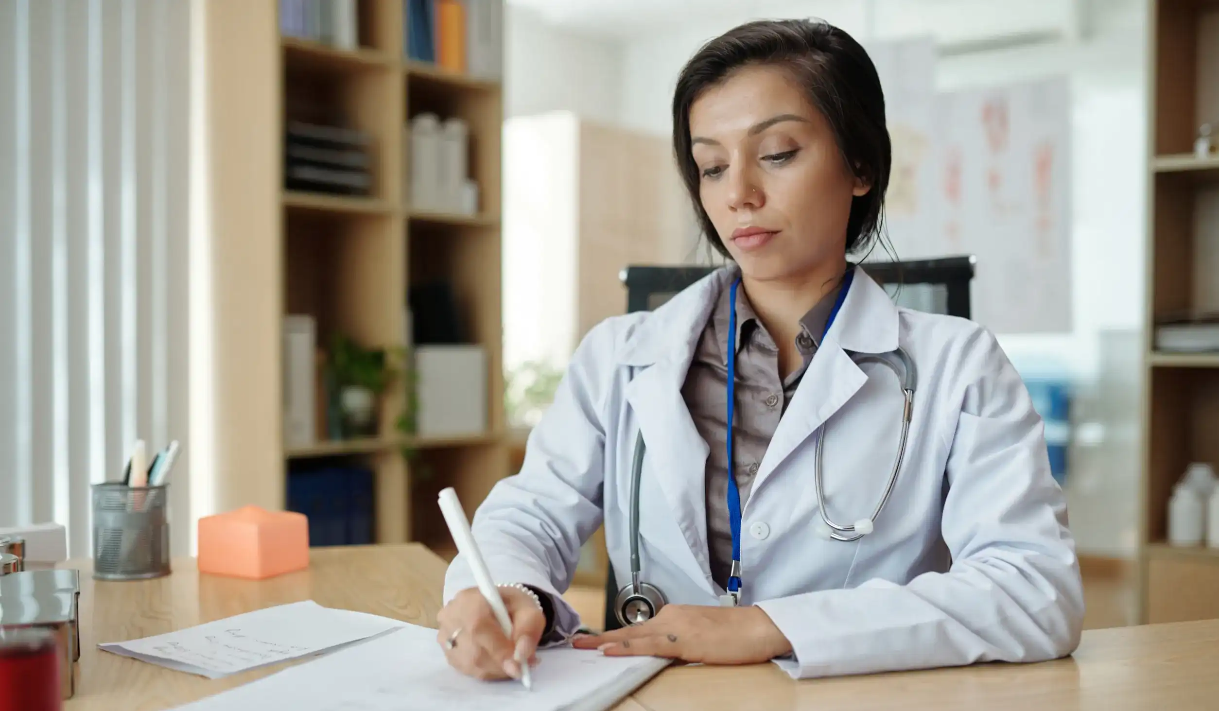 Doctor taking notes on Patient Wellness and Planning for Follow-up Appointment